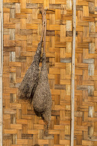 Close-up of wicker basket hanging on wood