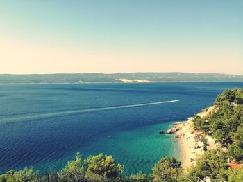 Scenic view of sea against clear blue sky