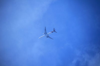 Low angle view of airplane flying in the sky
