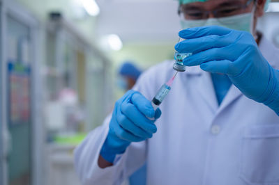 Midsection of person holding umbrella