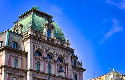 Low angle view of historical building against blue sky