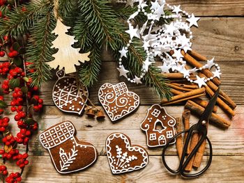 High angle view of gingerbread cookies and christmas decoration on table