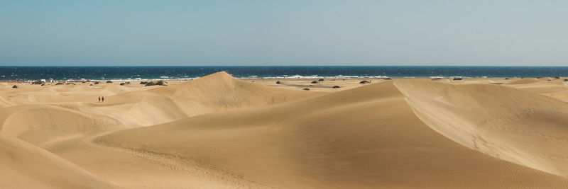 Panoramic view of beach against clear sky