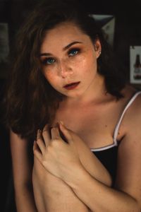 Portrait of young woman sitting at home