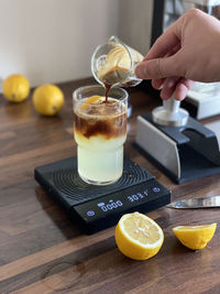 Cropped hand of drink on table