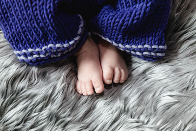 Close-up of baby girl lying on bed