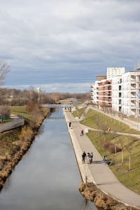 High angle view of lake by buildings against sky