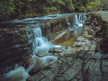 Water flowing through rocks in forest