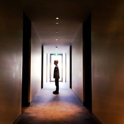 Rear view of woman walking in corridor