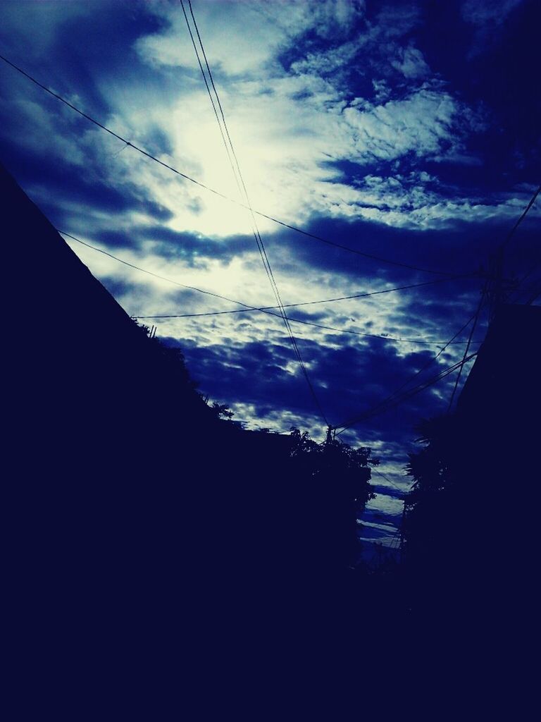 sky, power line, silhouette, cloud - sky, electricity pylon, low angle view, cable, electricity, power supply, cloud, cloudy, dusk, connection, scenics, built structure, nature, beauty in nature, outdoors, tranquility, architecture