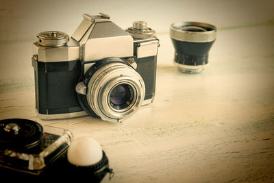 High angle view of camera and lens on table