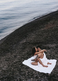 High angle view of woman lying on beach