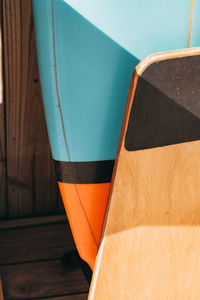 High angle view of orange and blue surfboards 