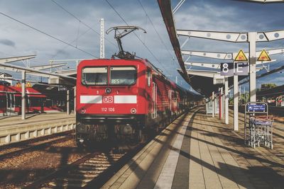 Train at railroad station against sky