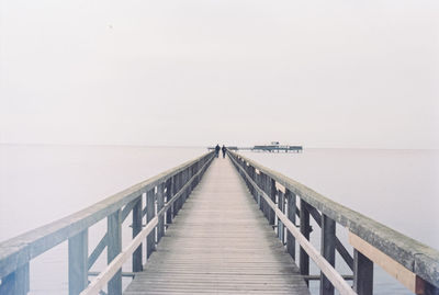 Pier over sea against clear sky