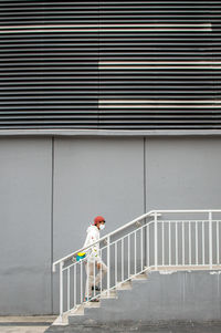 Man walking on staircase of building