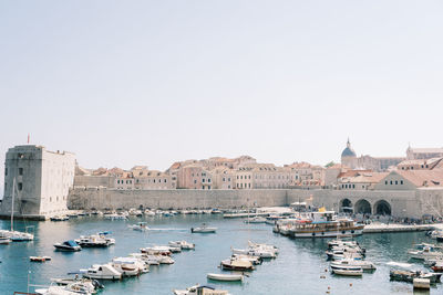 Boats in sea against clear sky