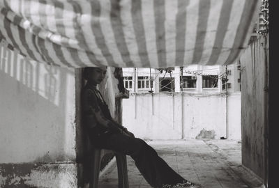 Thoughtful woman sitting on stool