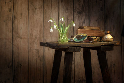 Close-up of flowers and books on table