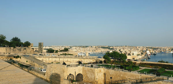 Buildings in city against clear sky