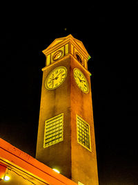 Low angle view of illuminated building against sky at night