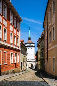 Street amidst buildings against sky in city