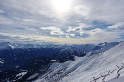 Scenic view of snowcapped mountain against cloudy sky