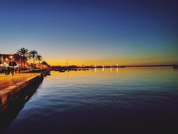 Scenic view of river against sky at sunset