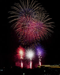 Low angle view of firework display at night