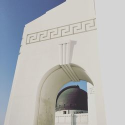 Low angle view of white arch wall