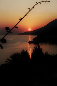 Scenic view of lake against romantic sky at sunset