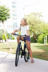 Full length of woman with bicycle