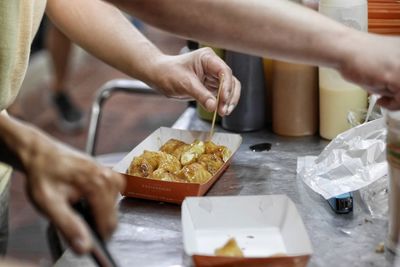 Midsection of person preparing food on table