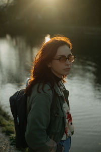 Portrait of a young woman during sunset