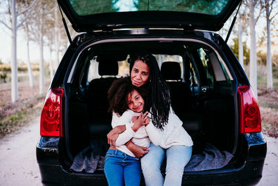 Full length of woman sitting in car