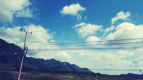 Scenic view of mountains against cloudy sky