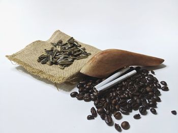 High angle view of coffee beans against white background