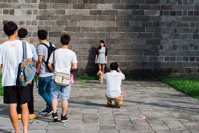 Rear view of people walking outdoors