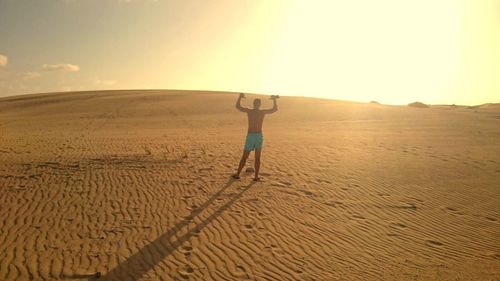 People walking on sandy beach