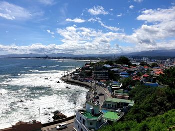 High angle view of sea and buildings against sky