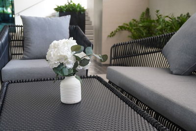 Close-up of flower vase on table at home
