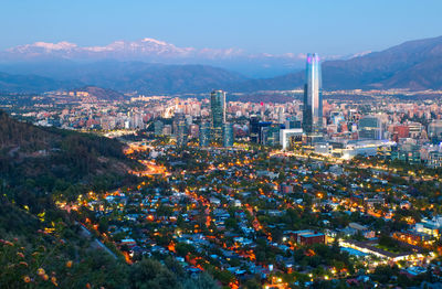 High angle view of illuminated city buildings against sky