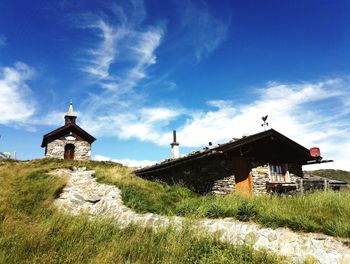 Church by building against blue sky