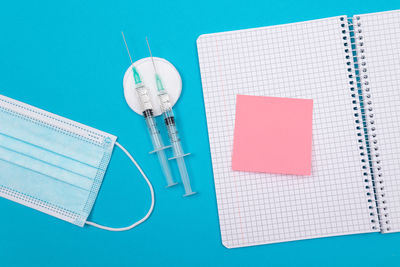 High angle view of pen on table against blue background