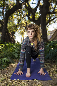 Portrait of woman practicing yoga in forest