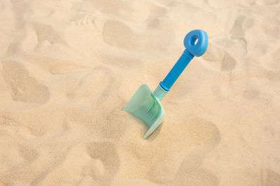 High angle view of plastic toy on beach