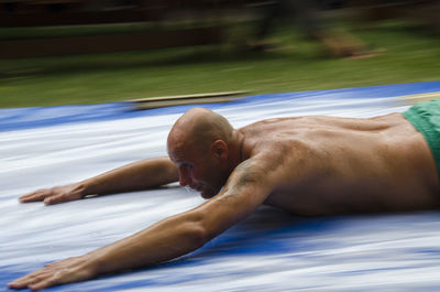 Full length of shirtless man in swimming pool