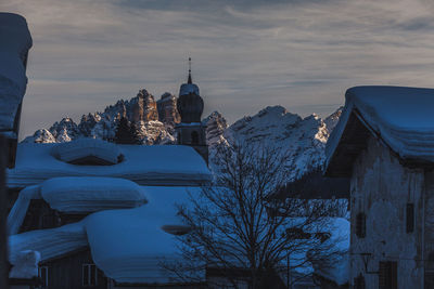 Roofs covered of snow and bell tower of the mareson village, dolomites, italy