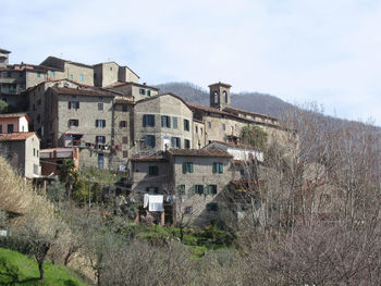 Buildings in town against sky