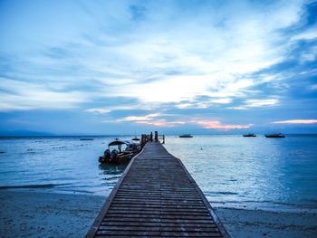 Pier over sea against sky